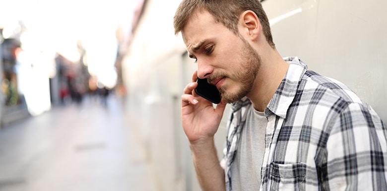 Upset man calling for help with cell phone