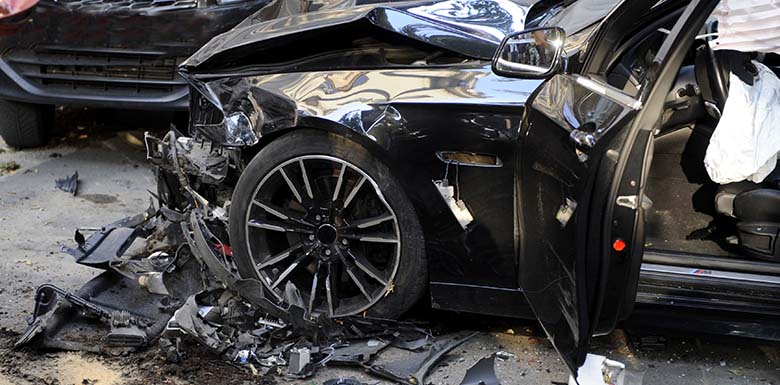 Black car destroyed in a wreck