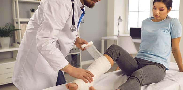Woman getting leg wrapped in a cast